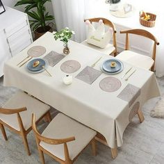 a dining room table set with place settings