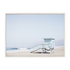 a lifeguard tower sitting on top of a sandy beach