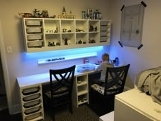 a small child sitting at a desk in a room with shelves and toys on the wall