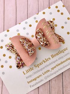 two little sparkles boutique pink and gold glitter bow clippers on top of a card