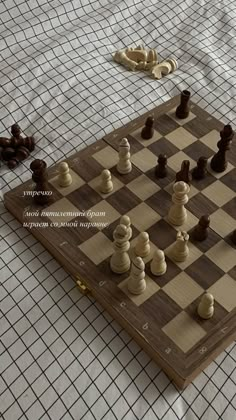 a wooden chess board with pieces on it