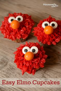 three red cupcakes with googly eyes are on a wooden table and the title says easy elmo cupcakes