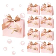 six pink gift boxes with gold bows and the words happy new year written on them