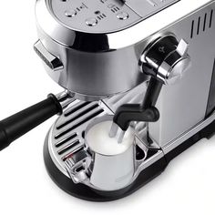 an espresso machine with milk being poured into it