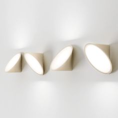 three light fixtures mounted on a white wall