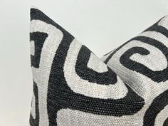 two black and white pillows on top of each other