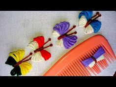 four different colored hair combs sitting next to each other