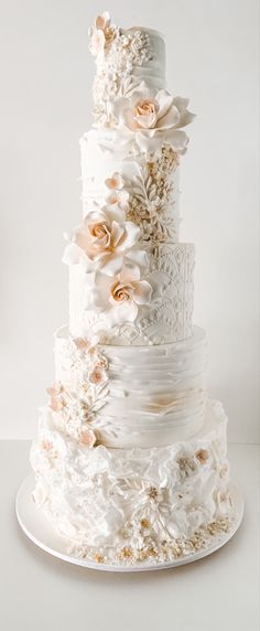 a white wedding cake with flowers on top