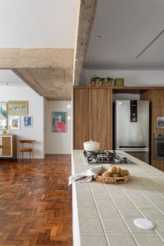 a kitchen with wooden floors and white walls