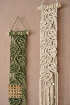 two green and white macrame hangings on a wall next to each other