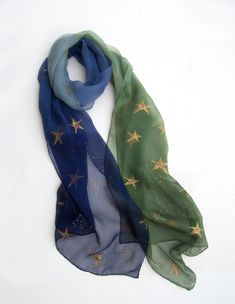 Hand painted ombre scarf with golden stars. Blue green large scarf painted by hand. Emerald and blue long scarf. Silk chiffon scarf. Christmas gift for mom, gift for granny. Woman fashion scarf. Dark silk scarf. size is:17'by 70' = 45 by 180 cm, A silk scarf will give a perfect finishing touch to any outfit, whether it be dressy or casual. It can also be worn as a hair band or a belt. It will make a wonderful one-of-a-kind gift. The silk has been painted with reactive dye that becomes part of th Celestial Scarf, Painted Christmas Gifts, Outfit Pieces, Ombre Scarf, Christmas Gift For Women, Velvet Scarf, Silk Chiffon Scarves, Hand Painted Scarves, Painted Scarf