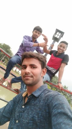 three young men are posing for the camera