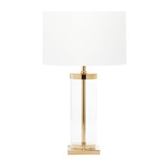 a gold lamp with a white shade on the base and a light bulb attached to it