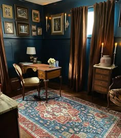 a room with blue walls and pictures on the wall, including a desk in front of a window