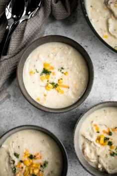 four bowls filled with soup on top of a table