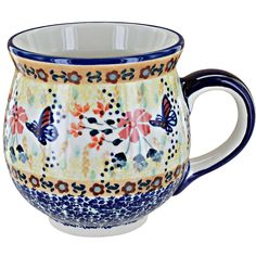 a blue and white coffee mug with butterflies on the outside, sitting in front of a white background