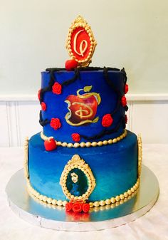 a blue cake with red decorations on it