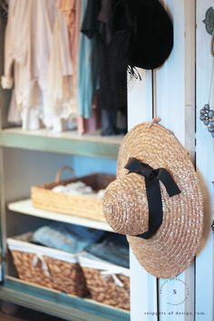 a hat hanging on the side of a closet