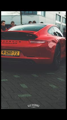 a red sports car parked in front of a building