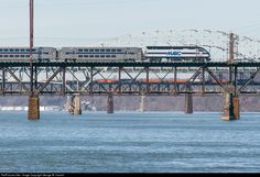 a train traveling across a bridge over water