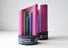 several pink and blue toothbrush holders stacked on top of each other with the words national design award in front of them