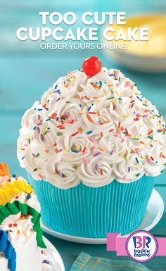 a blue cupcake with white frosting and sprinkles on the top