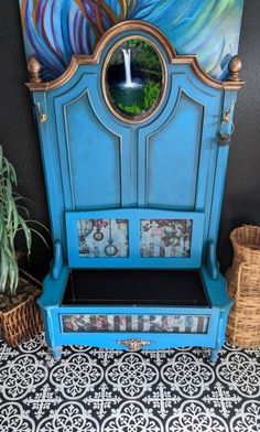 a blue bench sitting in front of a wall with a mirror on top of it