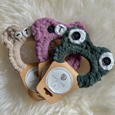 three crocheted eyeballs are sitting on top of a white furnishing