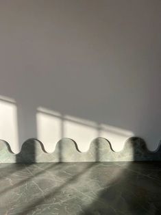 an empty room with the sun shining through the windows and casting shadows on the floor