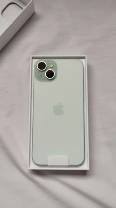 an iphone 11 pro in its box on a bed