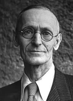 black and white photograph of an older man with glasses wearing a suit jacket and tie