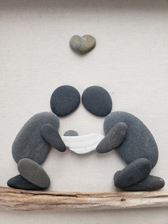 two rocks in the shape of people holding hands