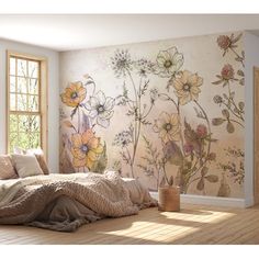 a bed sitting under a window next to a wall with flowers painted on the walls