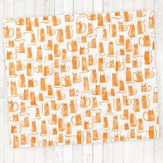 an orange and white pattern with cats on it