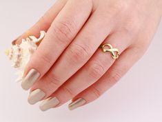 This Infinity Solid Gold Ring is perfect for stacking with other gold rings or wearing it by itself for an elegant look. * Item Details > Materials: 14K Solid Yellow Gold > Available: 14K Yellow Gold, Rose Gold, White Gold and 18K Yellow Gold, Rose Gold > Size: 4-10 US >Personalization is available > Stamps:  14K 18K G&D  > Made in USA with Love and Care by Jewelry Designer Gregory Simon > Brand: G&D Unique Designs *For the Dainty version of this ring please click the link below: https://www.ets Modern Twist Infinity Stackable Rings As Gift, Infinity Shape Stackable Fine Jewelry Rings As Gift, Gold Infinity Stackable Rings For Wedding, Gold Stackable Infinity Rings With A Modern Twist, Gold Infinity Stackable Rings With A Modern Twist, Fine Jewelry Infinity Stackable Rings As Gift, Gold Stackable Rings With Modern Twist In Infinity Shape, Fine Jewelry Stackable Infinity Rings As Gift, Modern Twist Gold Infinity Stackable Rings