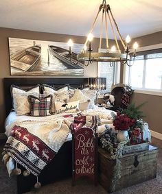 a bed room with a neatly made bed and christmas decorations