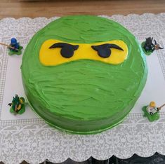 a green cake with yellow and black decorations