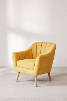 a yellow chair sitting on top of a white floor