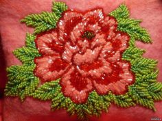 a close up of a woman's arm with beads and flowers on it