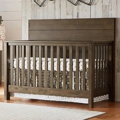 a baby crib in a room with wooden floors