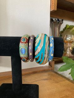 "4, Bangle Stack, Turquoise Bangles, Clamper Bracelets, Blue Bracelets, Small Wrist, iris apfel A group of 4 clampers, hinged bangles, bracelets from the 90s in complimentary colors! Diameter is 2\" - for a smaller wrist like mine! Group measures 3\". Wear one, two, or all at a time :) Perfect condition. Staff: Mid left inv - BLU3" Blue Unique Beaded Bracelets, Blue Bohemian Bangle Jewelry, Blue Bracelets With Unique Variations, Unique Blue Bangle Cuff Bracelet, Handmade Blue Costume Jewelry Bracelets, Unique Adjustable Blue Bangle, Blue Bracelet With Unique Variations, Unique Blue Bangle Jewelry, Unique Blue Bangle