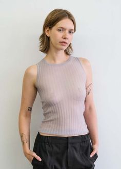 The ella is a sheer ribbed tank with a crew neckline. very stretchy.    please note that this garment is very delicate. handle and wear with care. Sheer Fitted Mesh Tank Top, Fitted Sheer Mesh Tank Top, Sheer Stretch Tank Top, Fitted Sheer Top With Scoop Neck, Fitted Tank Mesh Top For Spring, Fitted Mesh Tank Top For Spring, Stretch Sleeveless Mesh Top For Layering, Fine Knit Crew Neck Tank Top For Layering, Sheer Tank Top For Layering