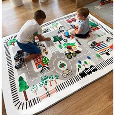 two young boys playing with toys on the floor