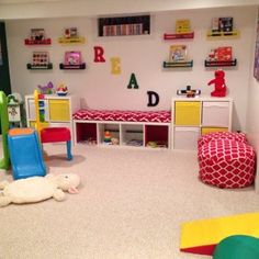 a child's playroom with toys and bookshelves