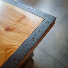 a wooden table with a ruler on it