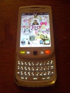 a cell phone sitting on top of a wooden table