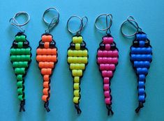 four key chains with different colored beads on them