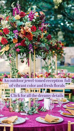 a tall vase filled with flowers sitting on top of a purple table cloth covered table