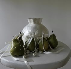 some pears and pearls are sitting on a table