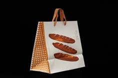 a paper bag with some hot dogs on it